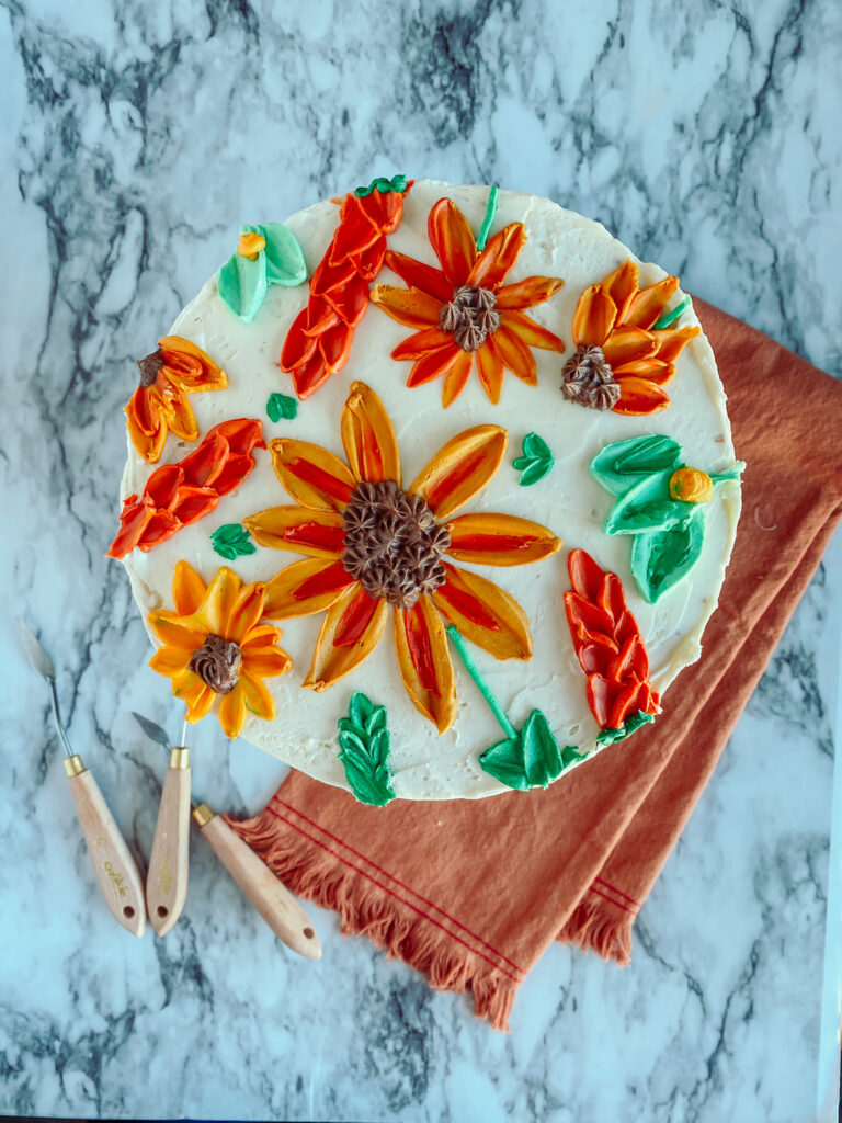red orange sunflower buttercream decorated cake