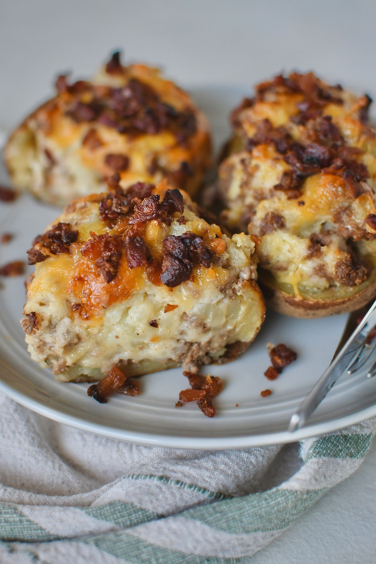 Cheeseburger Twice Baked Potatoes cut in half on a plate