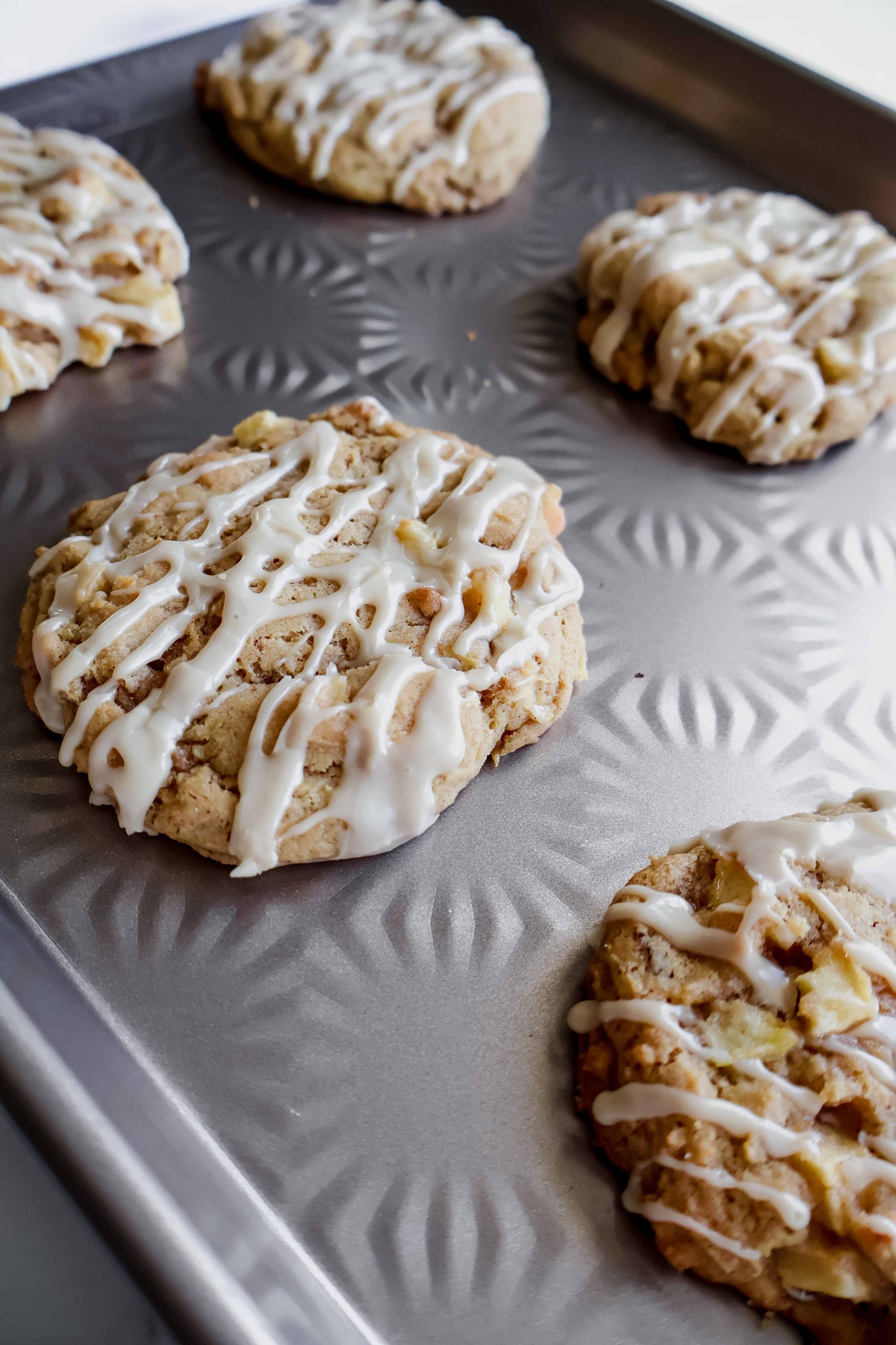 apple fritter cookie with maple glaze on a cookie sheet